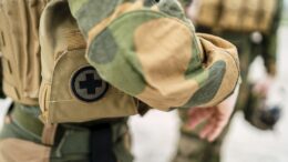 A closeup of a small first aid bag on the uniform of a special force soldier